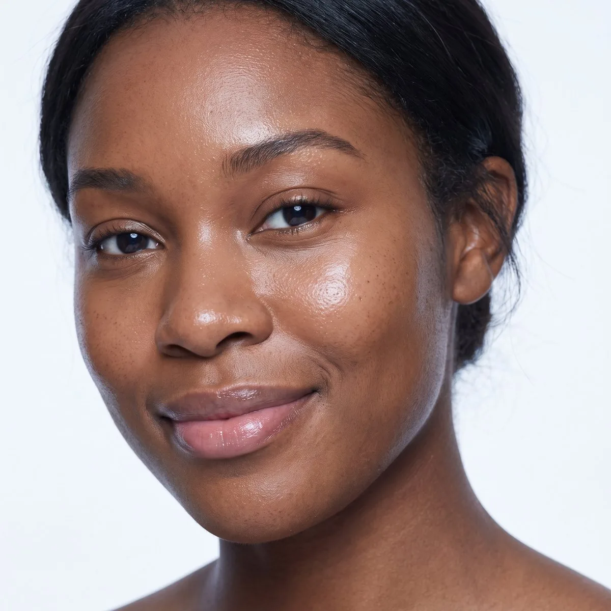 Close-up of glowing even facial skin after Clear + Brilliant at BHRC
