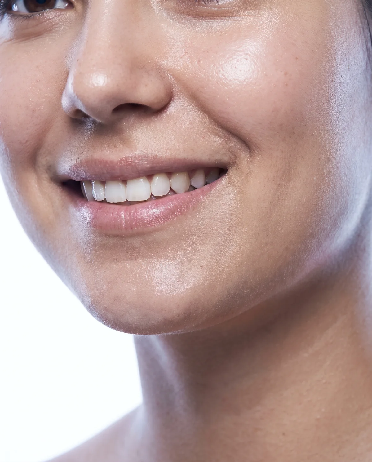 Close-up of a woman's smile on a white background