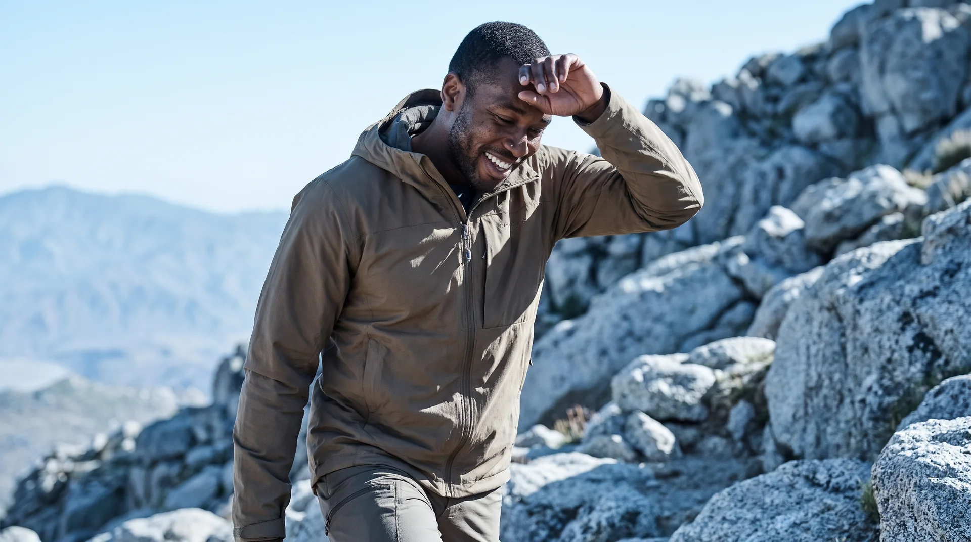 A man hiking a rocky trail on a clear day