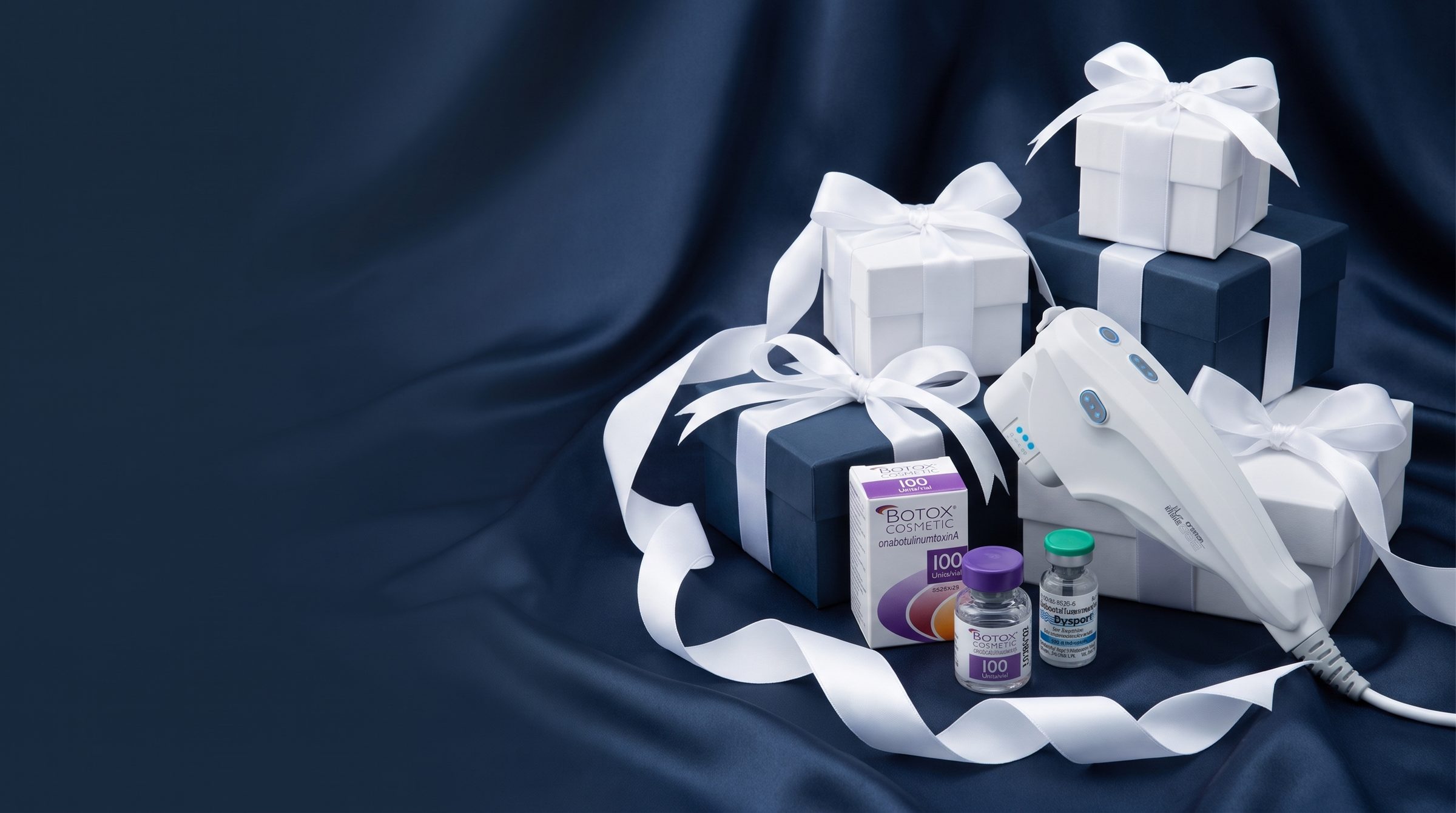 Ultherapy handpiece with Botox and Dysport vials and BHRC gift boxes on navy satin